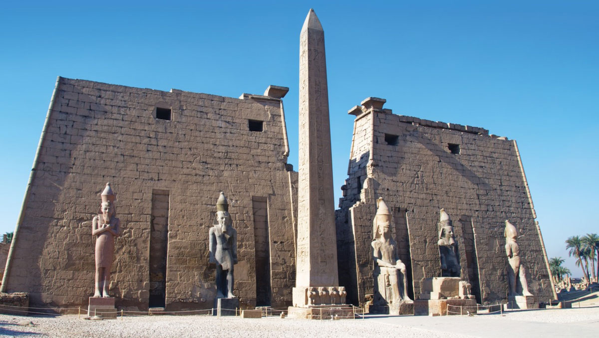Pylon (gateway) of Luxor temple with obelisk and statues