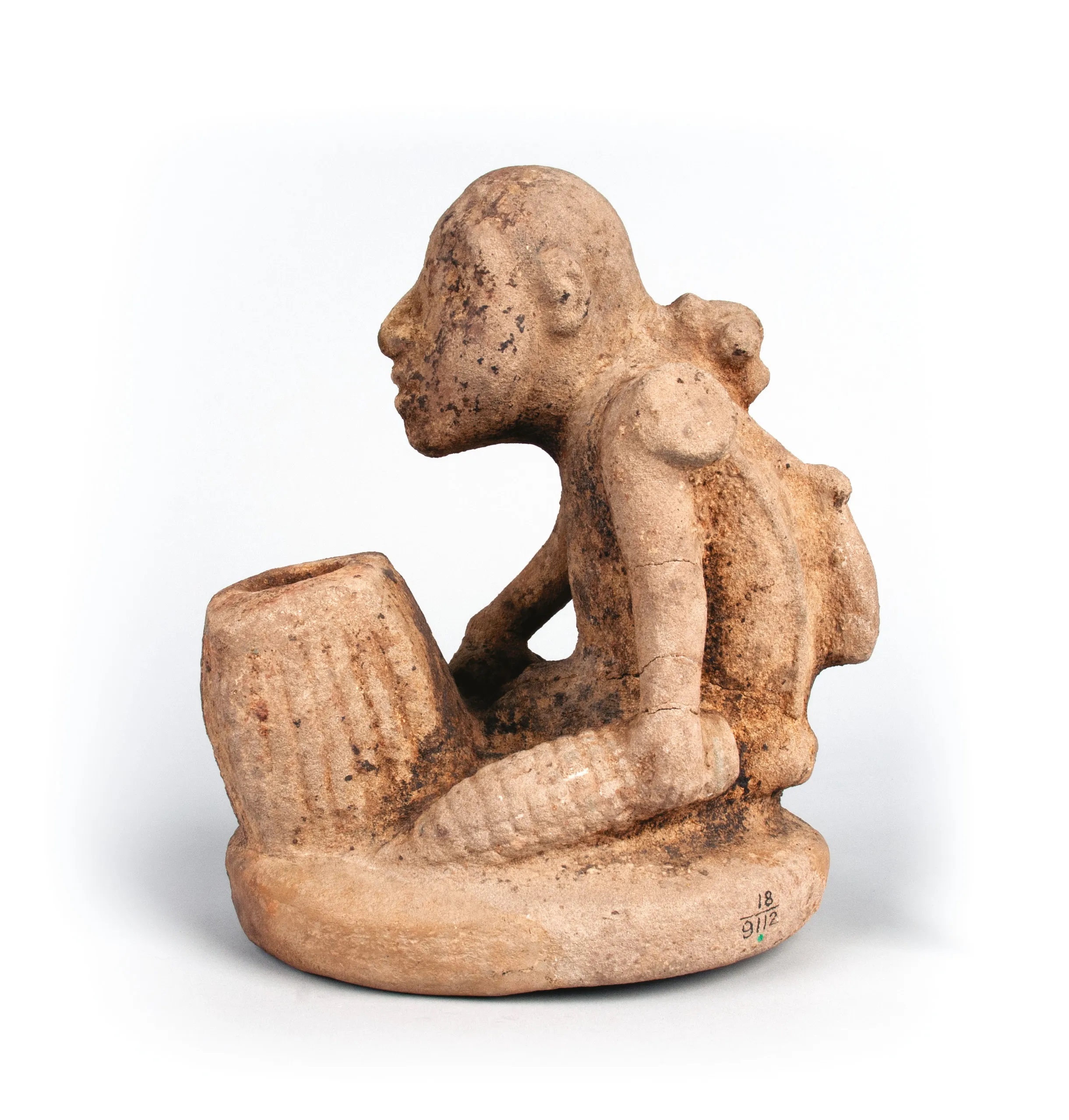 Stone effigy pipe shaped like Earthmother holding corn