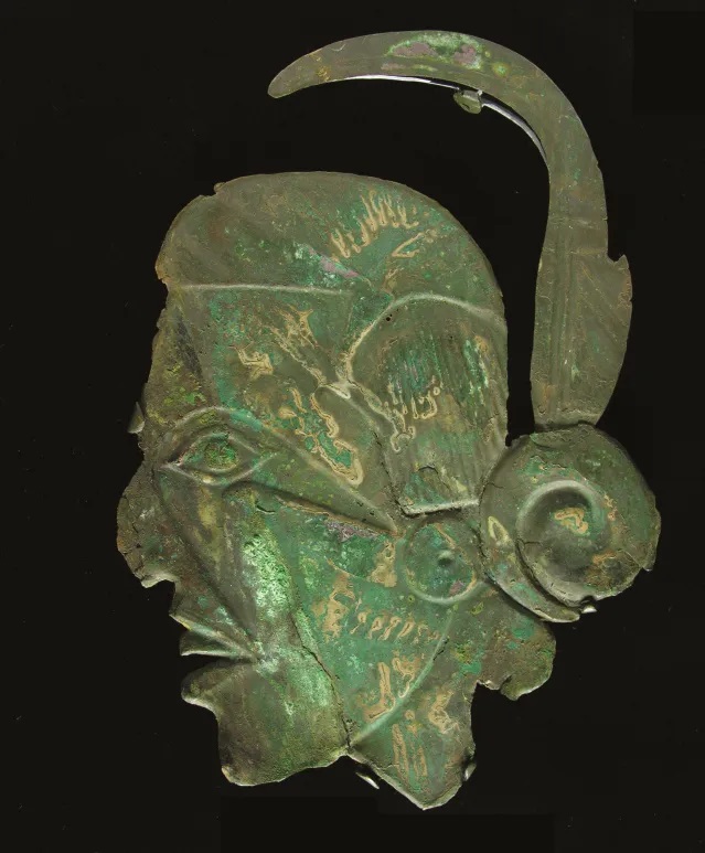 Copper effigy plate depicting a human head