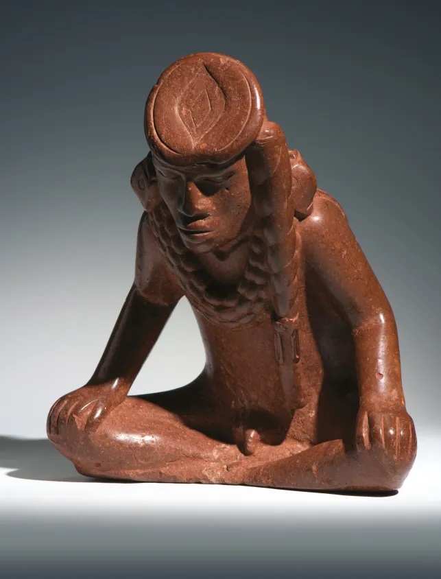Bauxite effigy pipe of a seated male figure, known as Resting Warrior