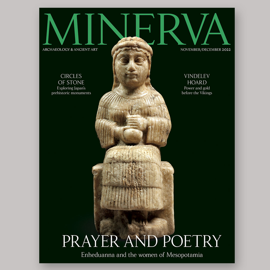 green magazine cover with image of statuette of seated female figure